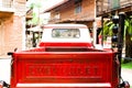Rear of Red classic Chevrolet apache pickup truck for park decoration at Ban Bang Khen.